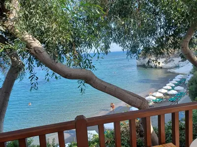 a view of a beach with people in the water at Niovi House in Tochni
