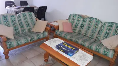 a living room with two chairs and a coffee table at Rita SeaView Apartment in Pervolia