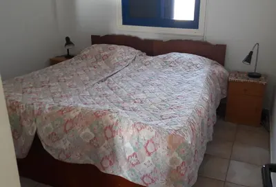 a bedroom with a bed with a quilt on it at Rita SeaView Apartment in Pervolia