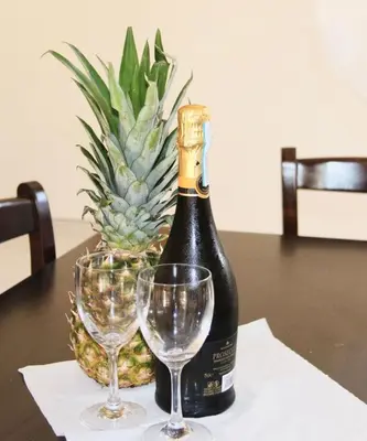 a bottle of champagne and two wine glasses on a table at Villa Stephania in Ayia Napa