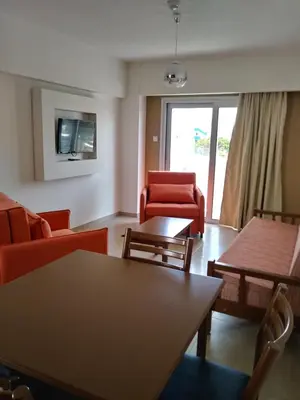 a living room with a couch and chairs and a table at Livas Hotel Apartments in Protaras