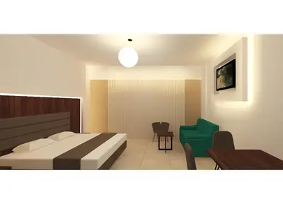 a bedroom with a bed and a green chair at Livas Hotel Apartments in Protaras