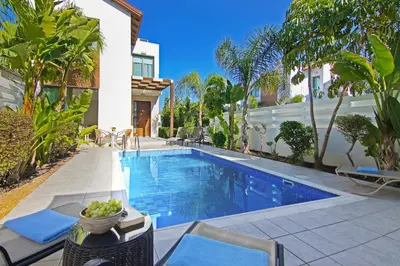 a swimming pool in the backyard of a house at Villa Maris in Protaras
