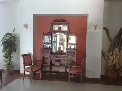 an old wooden dresser with chairs and a mirror at Aktea Beach Village in Ayia Napa