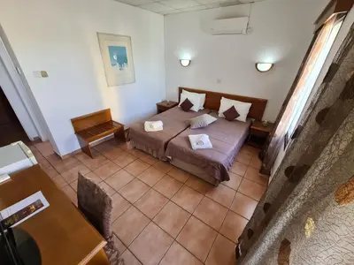 a bedroom with a bed and a table and a table at Metropole Hotel in Limassol