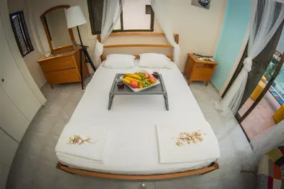 a bedroom with a bed with a tray of fruit on it at Villa Elena in Ayia Napa