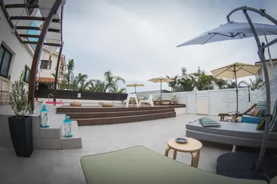 a patio with a couch and chairs and a table at Villa Elena in Ayia Napa
