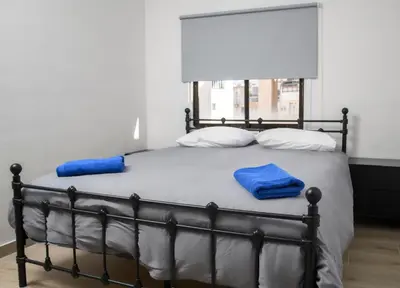 a bed with two blue towels on top of it at Ollies 3 Bedroom Apartment in Larnaka