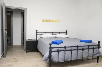 a bedroom with a bed with blue pillows at Ollies 3 Bedroom Apartment in Larnaka