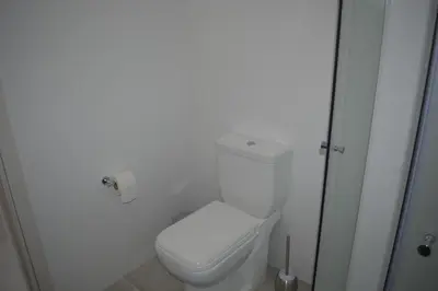 a bathroom with a white toilet in a room at P.L Hermes Studios & Apartments in Larnaka