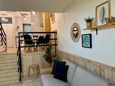a living room with a couch and a table at FatCow Beach House 43 in Larnaka