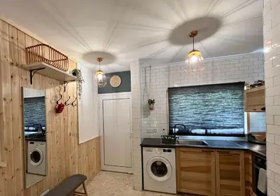 a kitchen with a sink and a washing machine at FatCow Beach House 43 in Larnaka