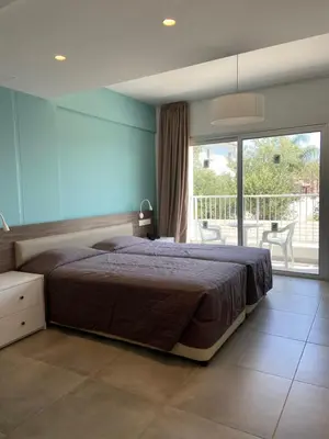 a bedroom with a large bed and a balcony at Sweet Memories Hotel Apts in Protaras