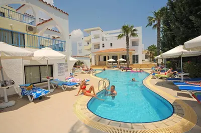 a group of people in a pool at a resort at Petrosana Hotel Apartments in Ayia Napa