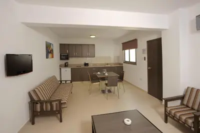 a living room with a couch and a table at Petrosana Hotel Apartments in Ayia Napa
