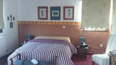 a bedroom with a bed with a striped blanket at Residence L' Aubrais in Limassol