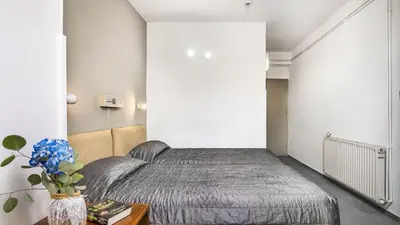 a bedroom with a bed and a vase with flowers on a table at Troodos Hotel & Spa in Troodos