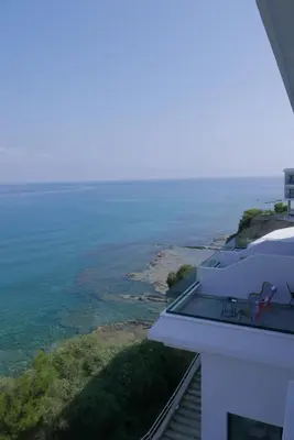 a view of the ocean from the balcony of a house at E.J. Pyrgos Bay Hotel in Kato Pyrgos
