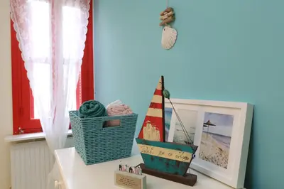 a shelf with a toy boat and a picture at Protaras Happy Sunny Holidays in Paralimni