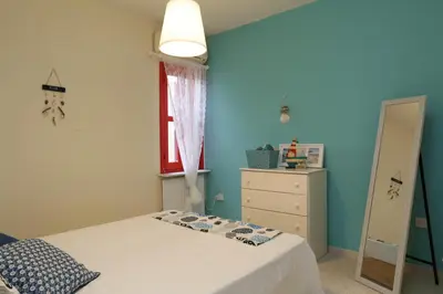 a bedroom with a bed and a dresser and a mirror at Protaras Happy Sunny Holidays in Paralimni