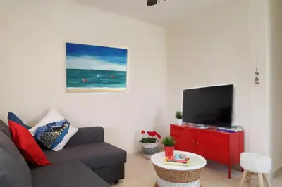 a living room with a couch and a flat screen tv at Protaras Happy Sunny Holidays in Paralimni