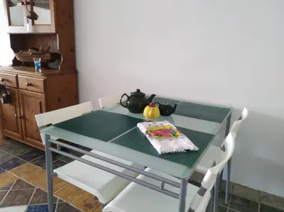a green table with a teapot on top of it at Il Mare in Larnaka