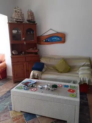 a room with a bed and a table with a ottoman at Il Mare in Larnaka