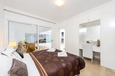 a bedroom with a bed and a living room at Villa Nausica in Protaras