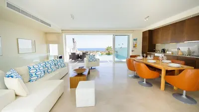 a living room with a couch and a table at Luxury Bay View Villa 28 Right On The Beach in Protaras