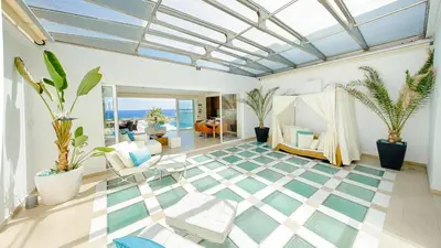 a living room with a glass ceiling and plants at Luxury Bay View Villa 28 Right On The Beach in Protaras