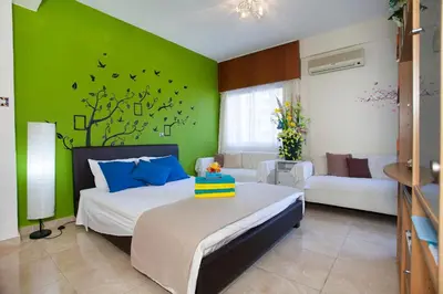 a bedroom with a bed and a green wall at Poseidon Boutique Apartment 1 in Limassol