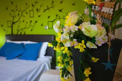 a vase filled with flowers in a bedroom at Poseidon Boutique Apartment 1 in Limassol