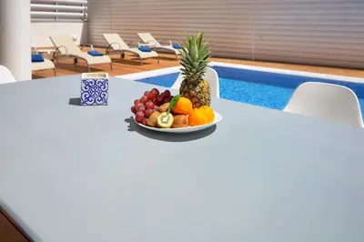 a bowl of fruit on a table next to a pool at Seaview Luxury Villa Jacuzzi & Pool! 2 Min Beach in Protaras