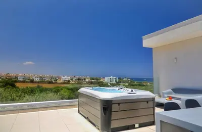 a hot tub in a balcony with a view of the ocean at Seaview Luxury Villa Jacuzzi & Pool! 2 Min Beach in Protaras