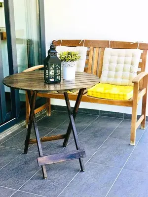 a wooden table with a bench and a table sidx sidx sidx sidx at Nicosia Cozy Nomad in Nicosia
