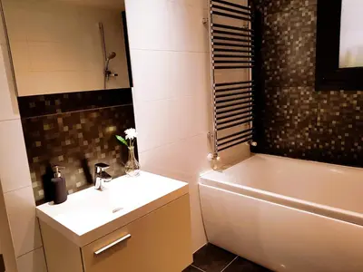 a bathroom with a sink and a toilet and a tub at Nicosia Cozy Nomad in Nicosia