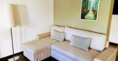 a living room with a couch with two pillows at Nicosia Cozy Nomad in Nicosia