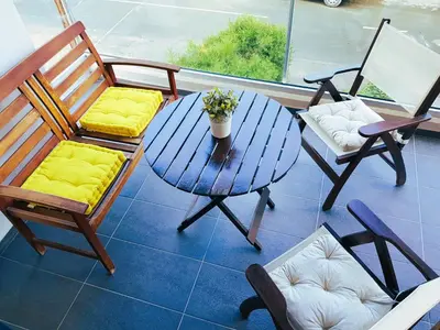 a table and chairs on a balcony with a table and chairs at Nicosia Cozy Nomad in Nicosia