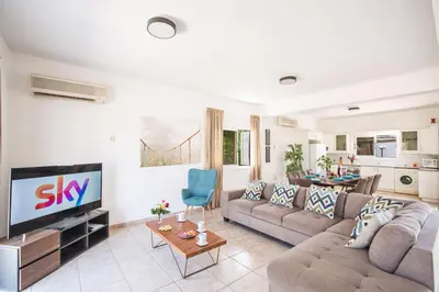 a living room with a couch and a tv at Jason Villas in Protaras