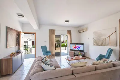 a living room with a couch and a tv at Jason Villas in Protaras