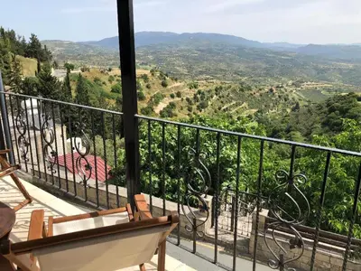 a balcony with chairs and a view of a valley at Pachna Studios - Village Life in Limassol