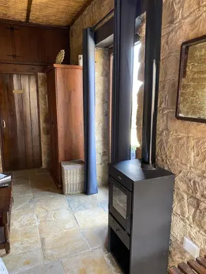 a wood stove in the middle of a room at Pachna Studios - Village Life in Limassol