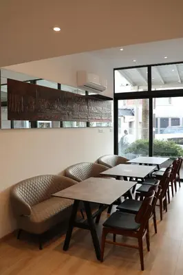 a group of tables and chairs in a restaurant at Sunflower Hotel Apartments in Larnaka