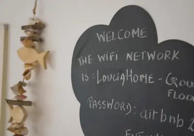 a blackboard with a welcome sign on a wall at Sunny Family Home By The Beach in Limassol