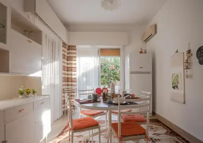 a kitchen with a table and chairs in a room at Sunny Family Home By The Beach in Limassol