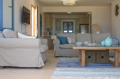 a living room with a couch and a table at Indigo in Protaras