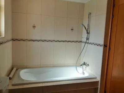a bath tub with a shower in a bathroom at ANTHORINA VILLA 9 in Protaras