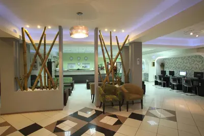 a lobby with a salon with chairs and a table at Windmills Hotel Apartments in Protaras