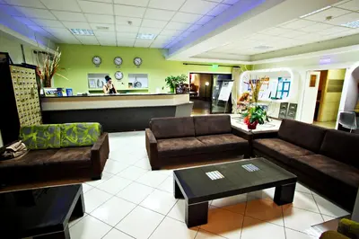 a lobby with couches and a bar in a pharmacy at Windmills Hotel Apartments in Protaras