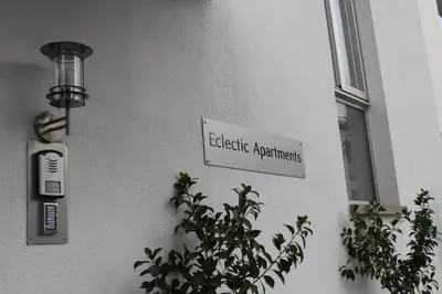 a sign on the side of a building with a plant at Eclectic Business & Leisure in Nicosia